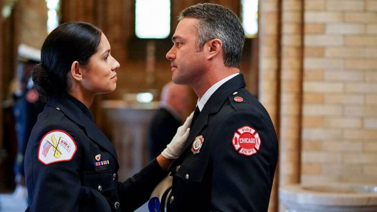 Miranda Rae Mayo as Stella Kidd stands in her dress blues and looks in the eyes of Taylor Kinney as Kelly Severide in his dress blues on Chicago Fire