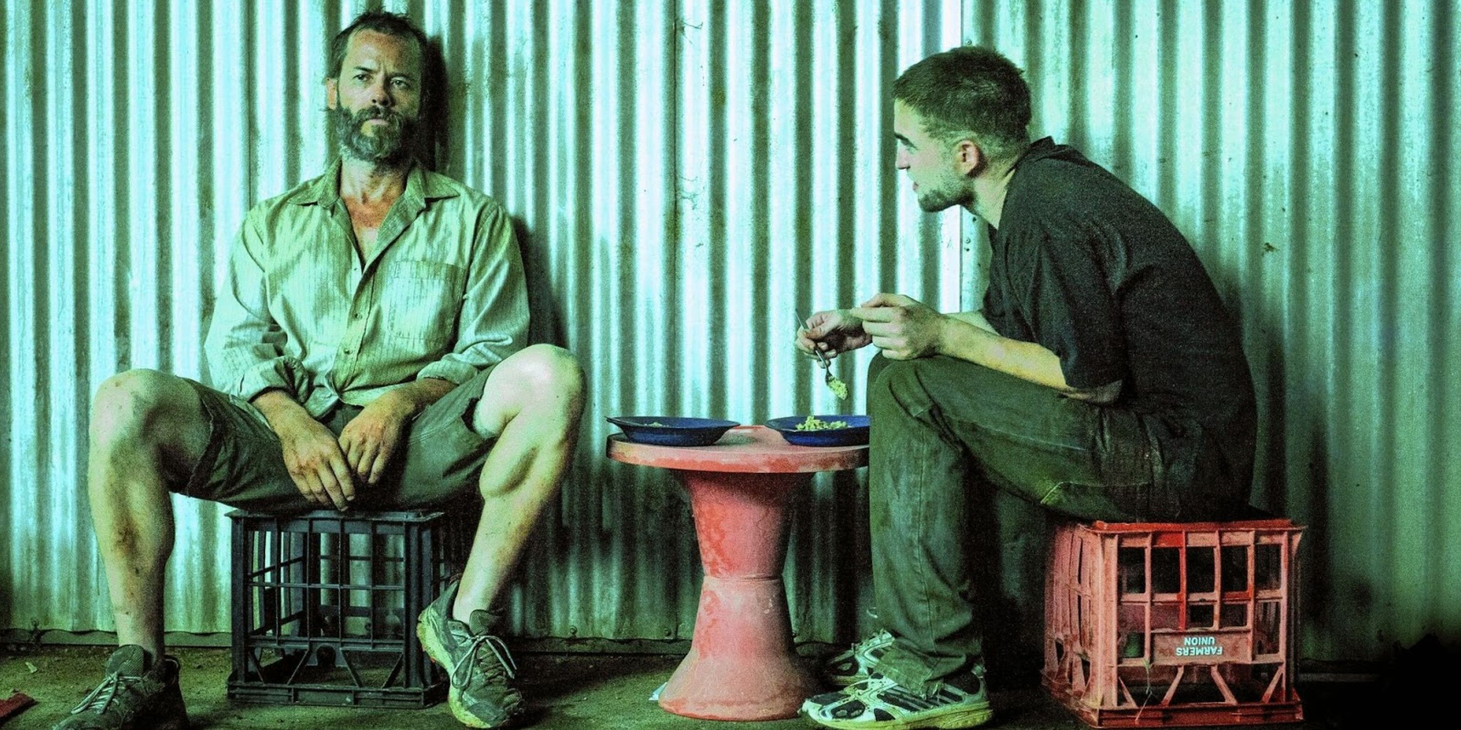 Robert Pattinson and Scoot McNairy talk while eating food in The Rover