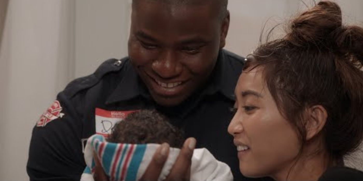 Okieriete Onaodowan as Dean Miller and Brenda Song as JJ Lau look down at their new baby on Station 19