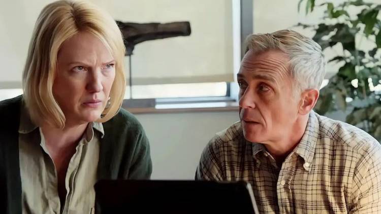 Robyn Coffin as Cindy Herrmann frowns at someone offscreen while sitting next to David Eigenberg as Christopher Herrmann on Chicago Fire