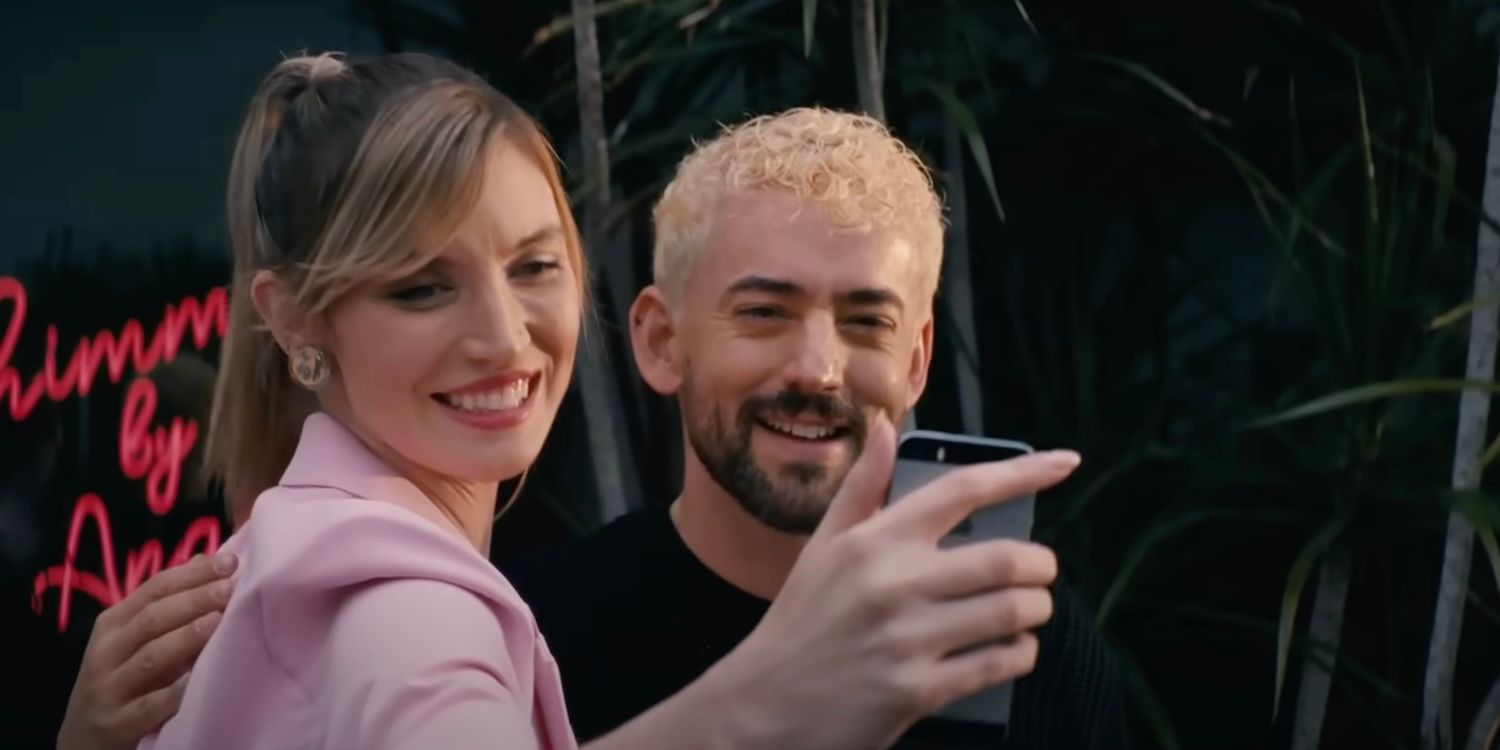 Angel (Luis Gerardo Mendez) takes a selfie with a fan in front of his salon in the film Skincare