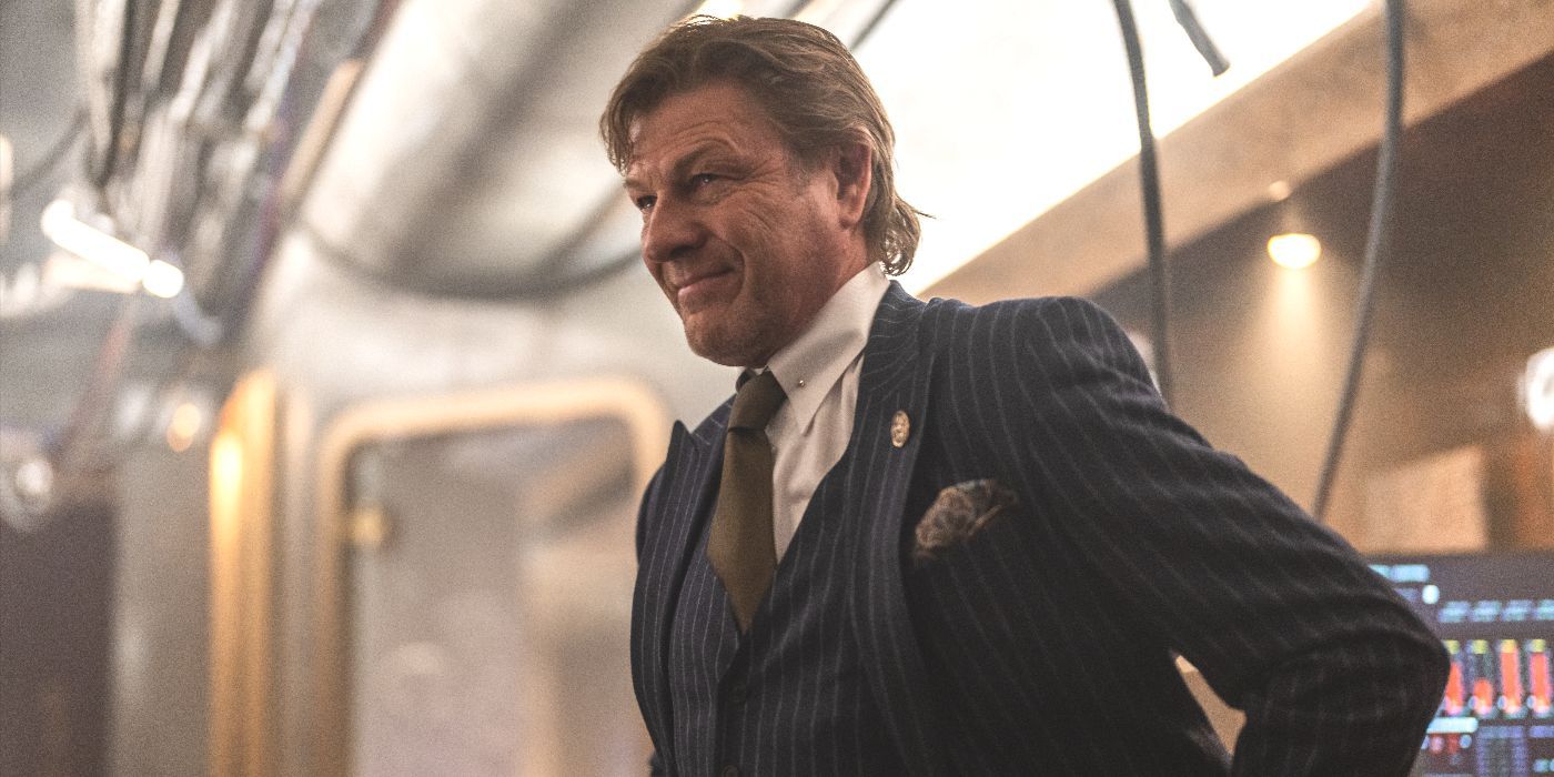 Joseph Wilford (actor Sean Bean) stands in a suit with his hands on his hips in Snowpiercer Season 4