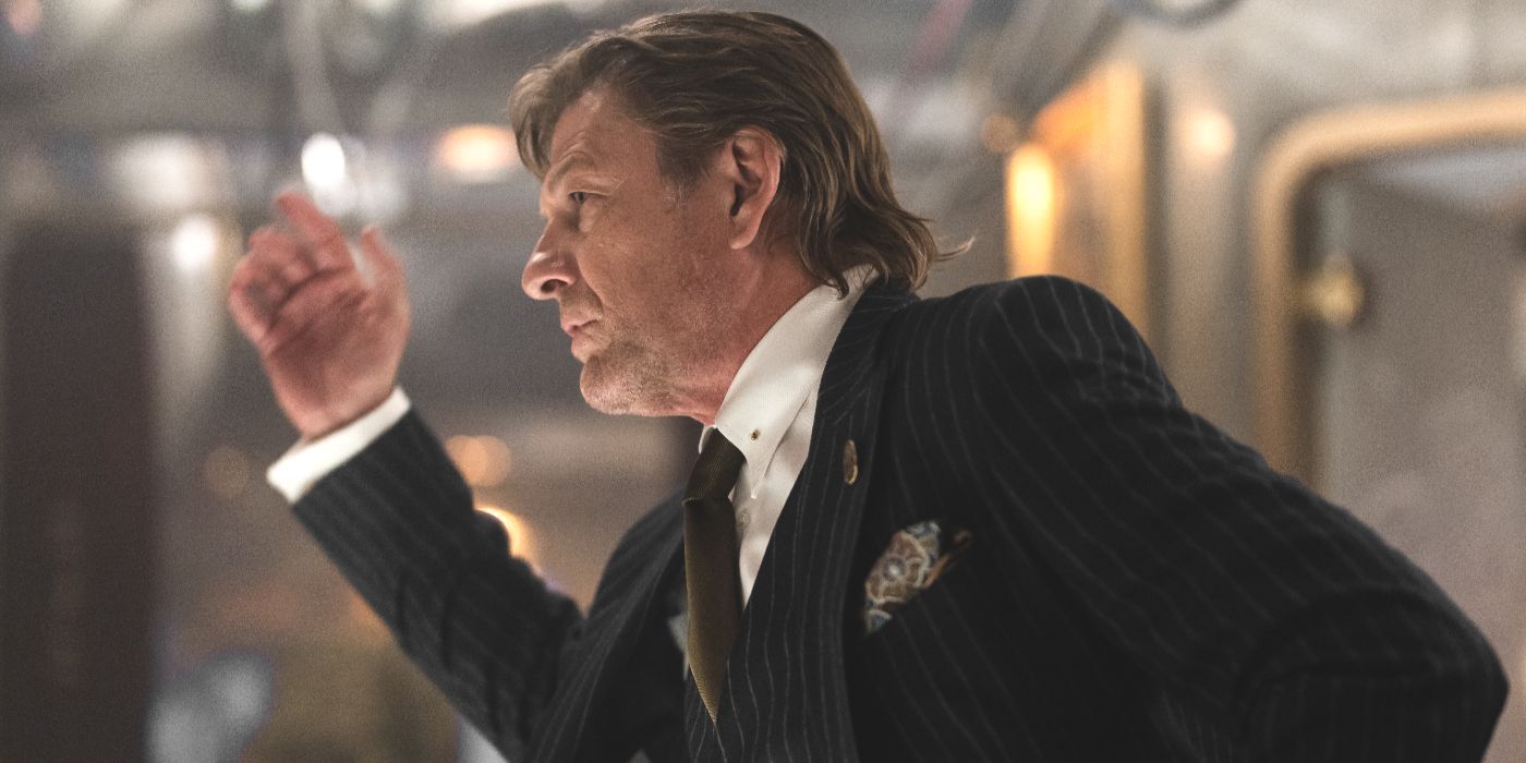 Wilford (actor Sean Bean) in a suit and tie looking off-camera in Snowpiercer Season 4