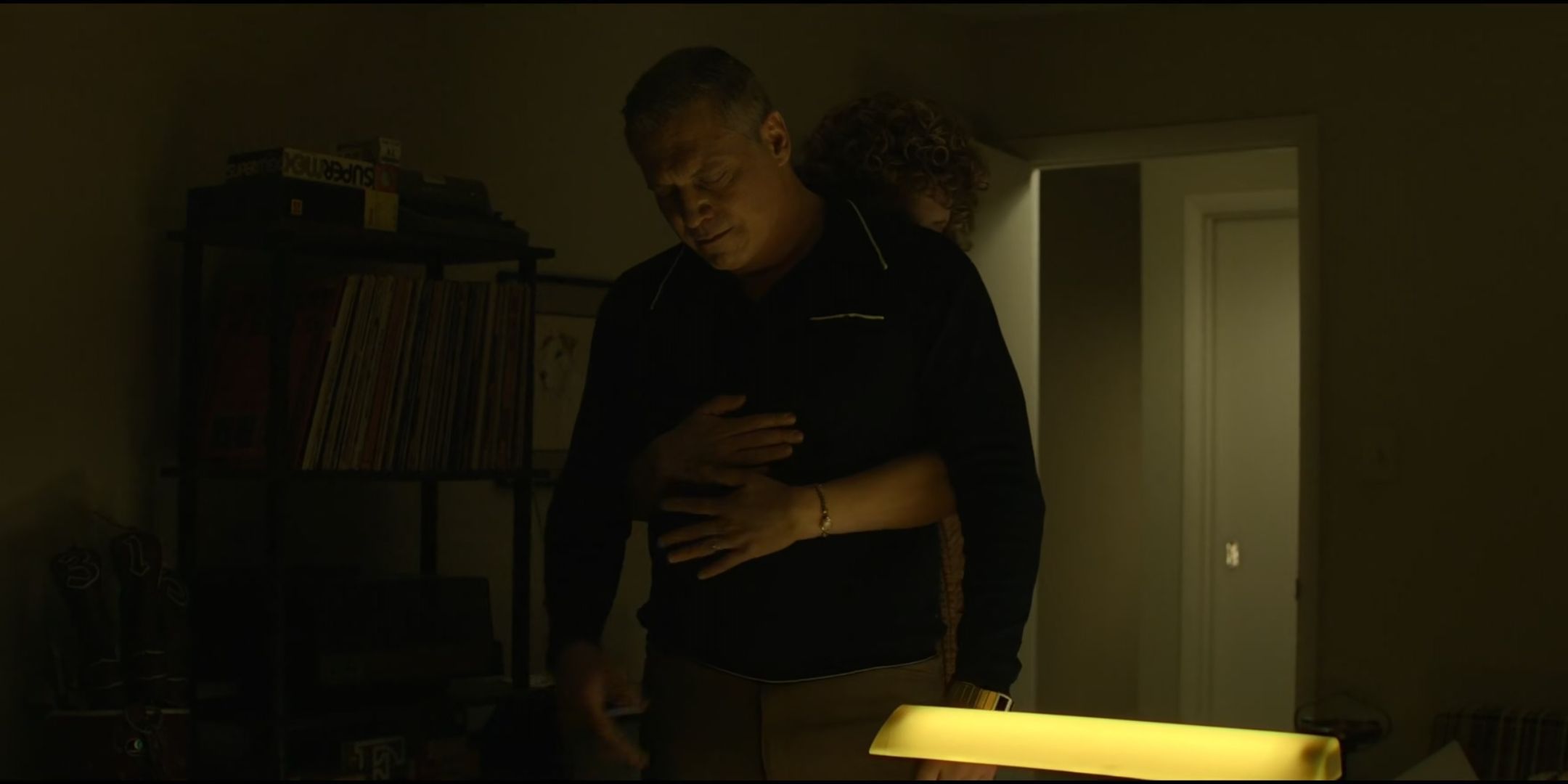 Stacey Roca as Nancy Tench puts her arms around Holt McCallany as Bill Tench from behind in Mindhunter