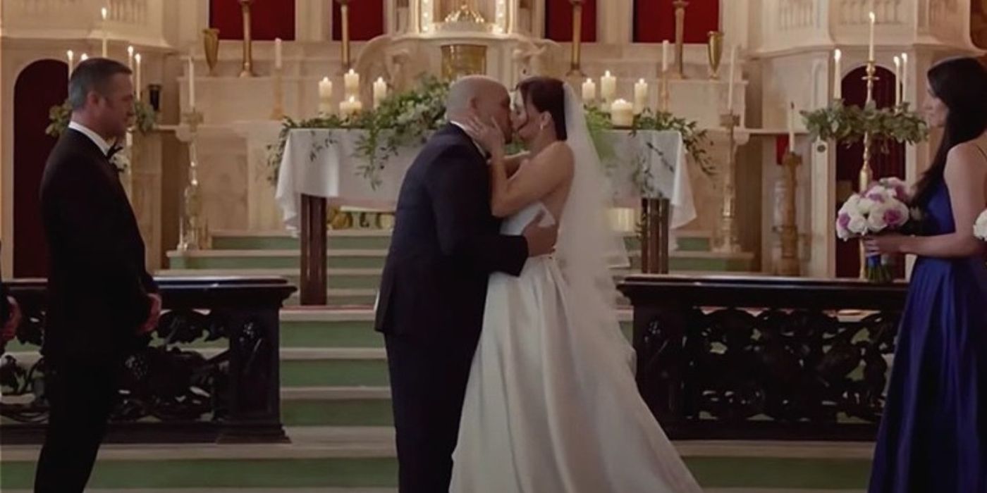 Taylor Kinney as Kelly Severide stands next to Joe Miñoso as Joe Cruz as he kisses his new bride Kristen Gutoskie as Chloe Cruz while Miranda Rae Mayo as Stella Kidd stands behind her in a Catholic church on Chicago Fire