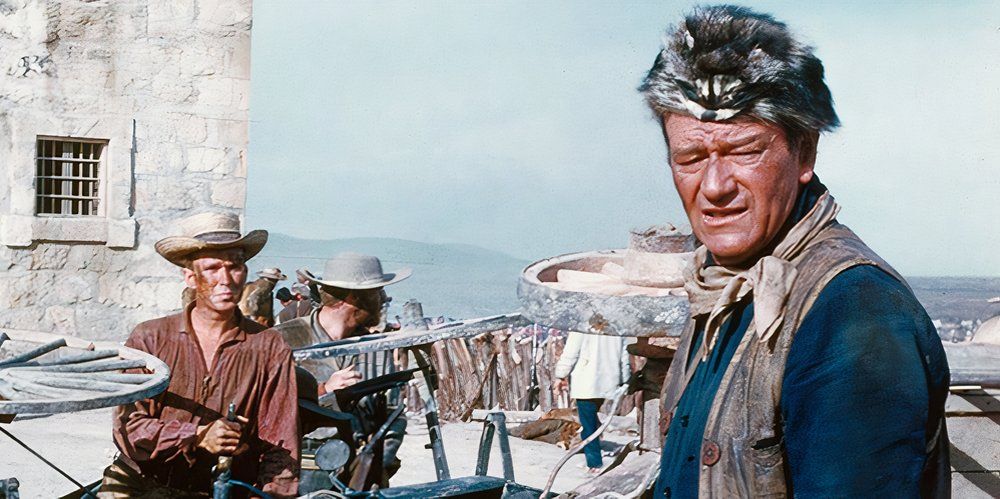 John Wayne as Davy Crockett prepares to defend the Alamo