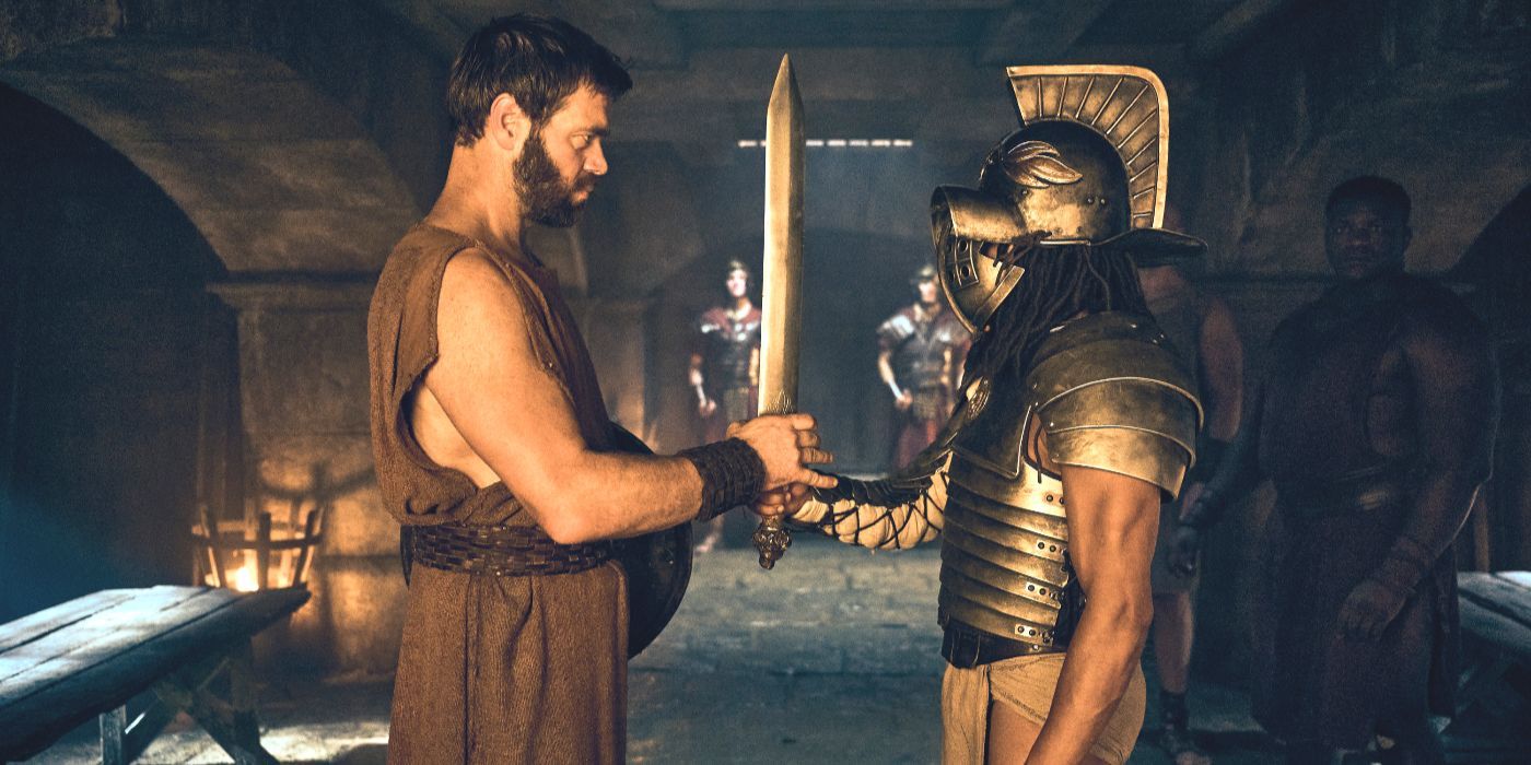 Viggo hands a sword to a fully armored Kwame in episode 7 of “Those About to Die”