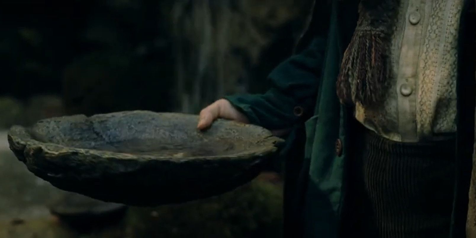 Pippin holding a bowl of Ent-draught in The Lord of the Rings: The Two Towers