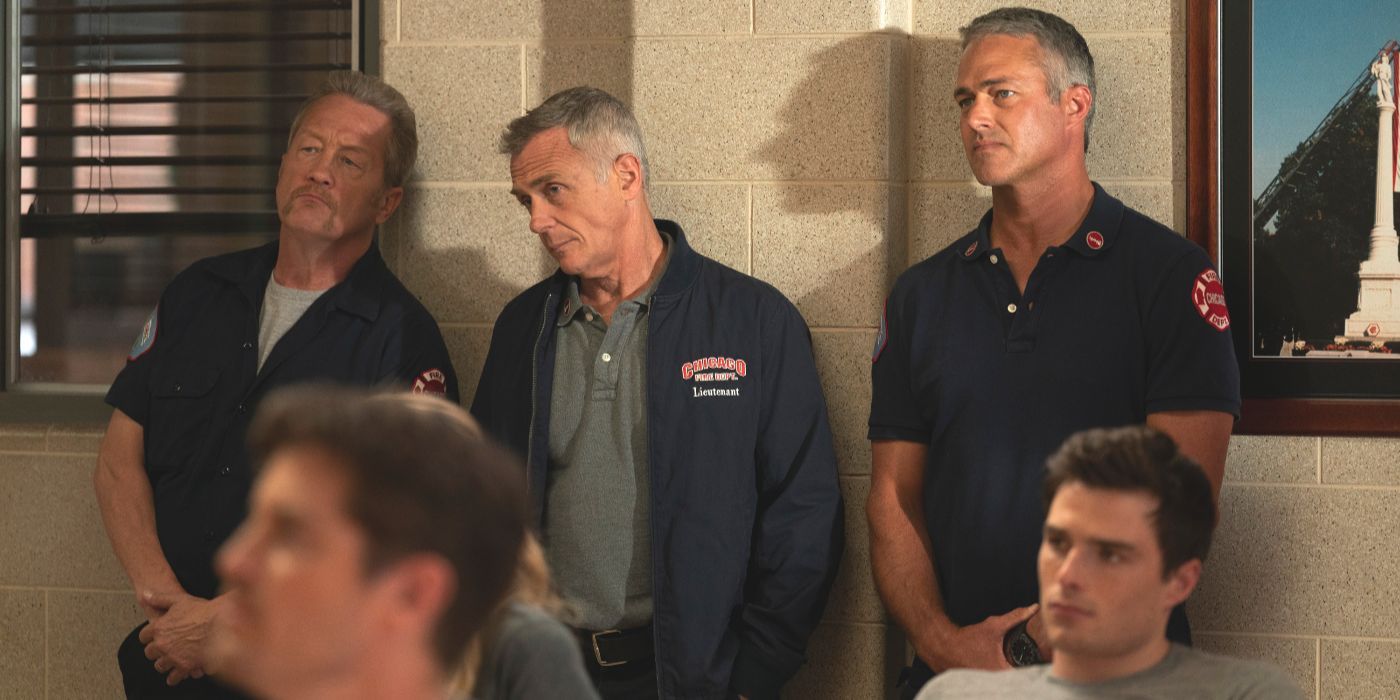 Mouch, Herrmann and Severide stand skeptically in the back of a firehouse meeting on Chicago Fire