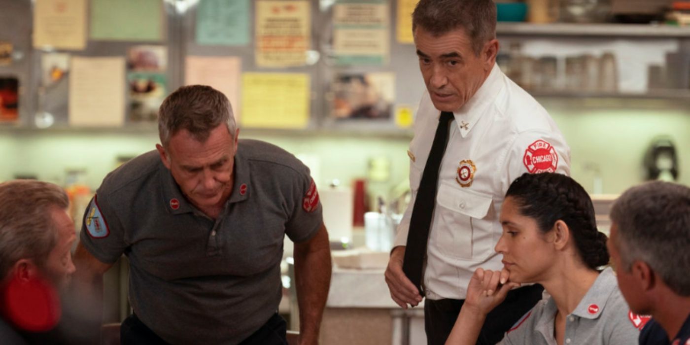 David Eigenberg as Christopher Herrmann sits down while Dermot Mulroney as Dom Pascal stands next to Miranda Rae Mayo as Stella Kidd while talking to the team on Chicago Fire