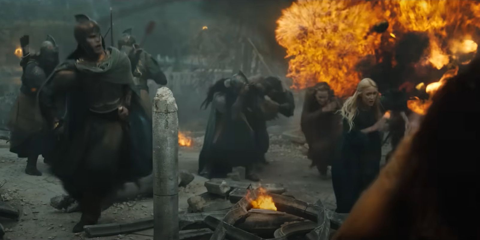 Elves run from an explosion during The Siege of Eregion in The Lord of the Rings: The Rings of Power