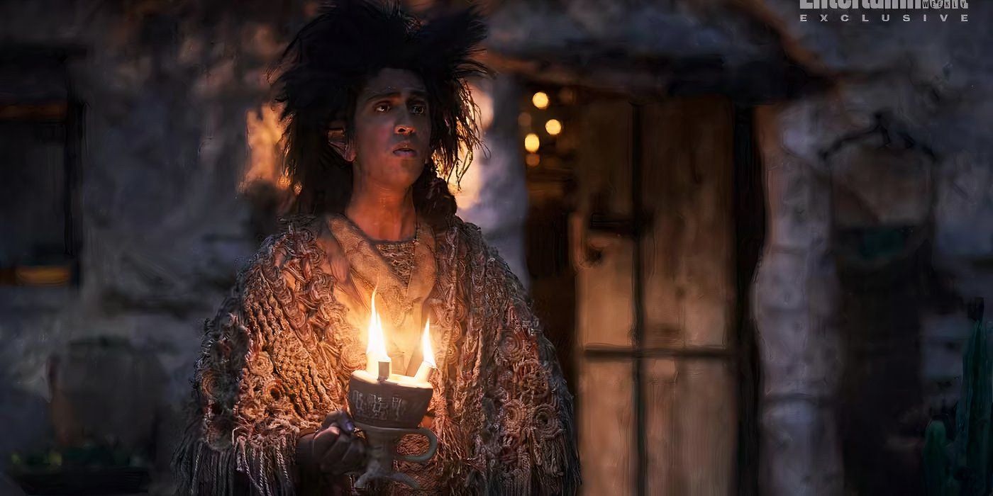 Merrimac the Stoor, played by Gavi Singh Chera, holds a candle in The Rings of Power