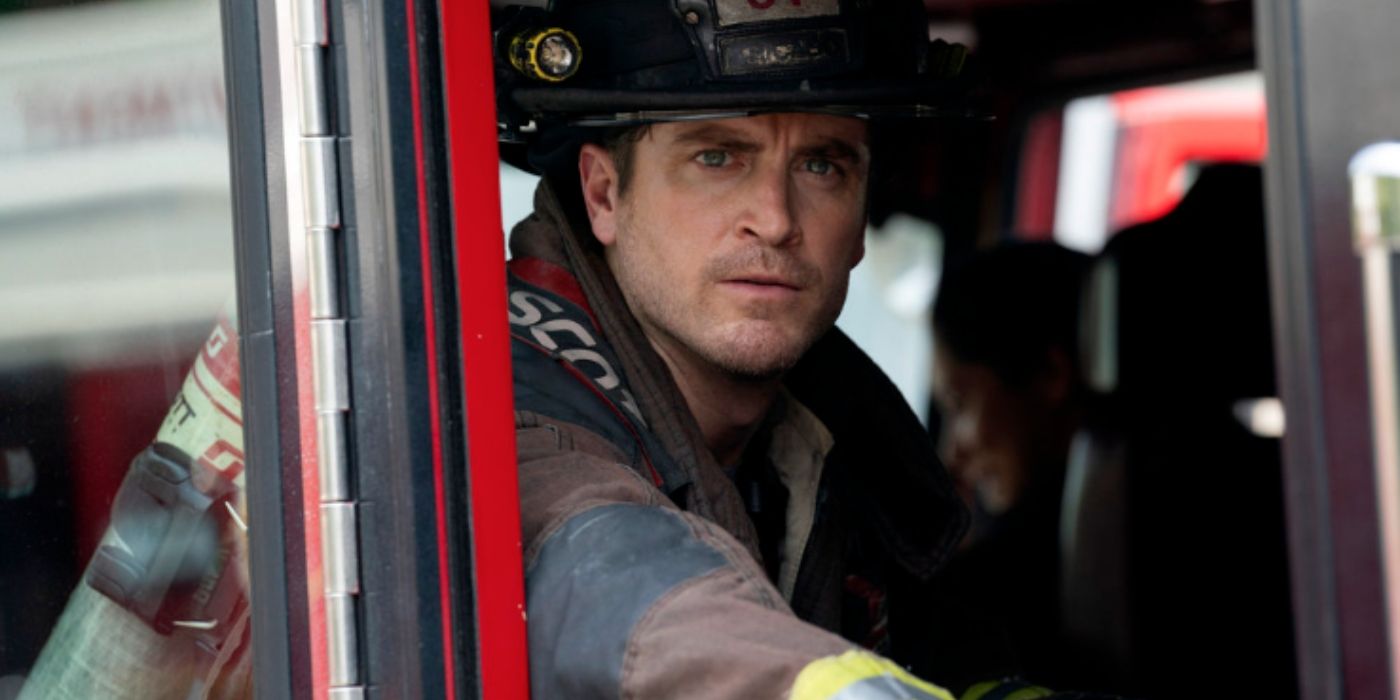 Jake Lockett as Sam Carver sits inside a fire truck in his turnout gear on Chicago Fire