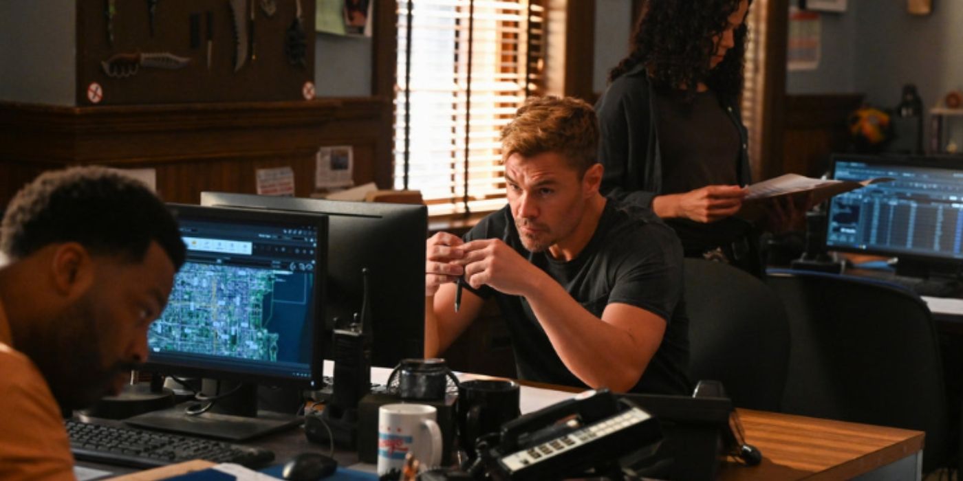 LaRoyce Hawkins as Kevin Atwater looks at paperwork in front of his computer while sitting across from Patrick John Flueger as Adam Ruzek sits across from him in front of his computer on Chicago PD