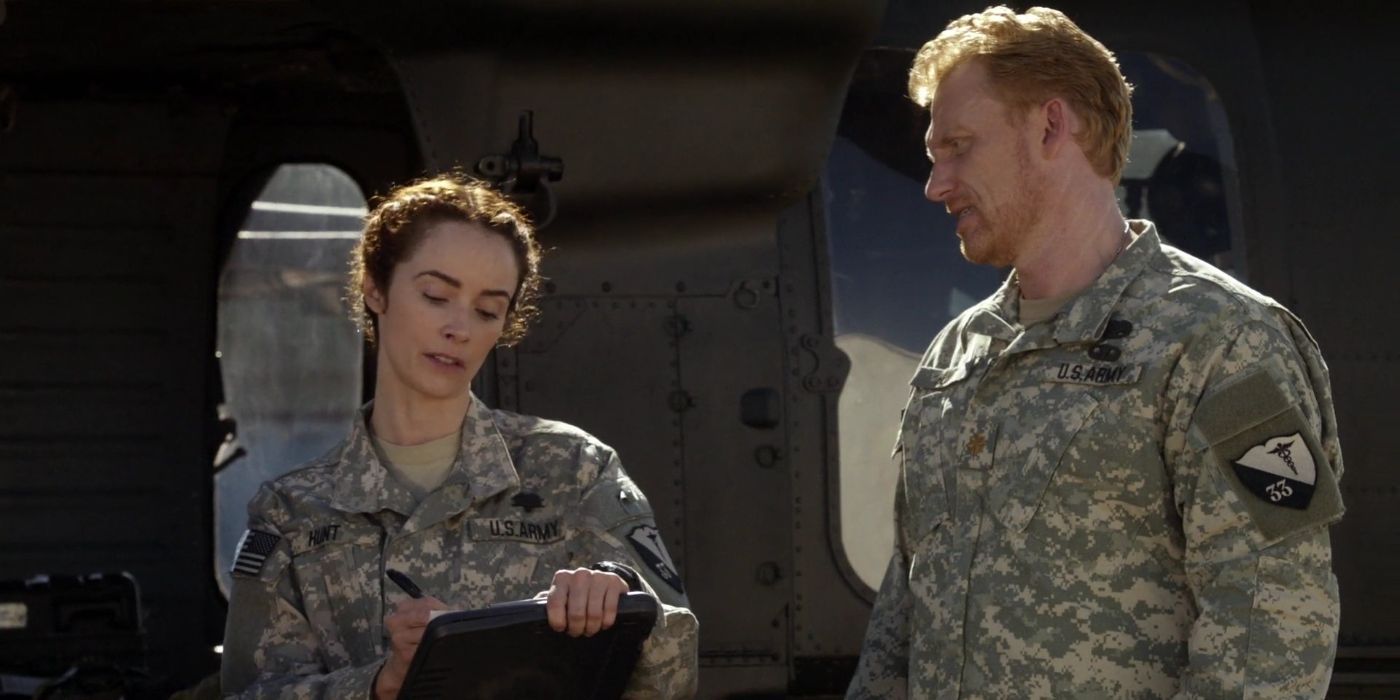 Megan Hunt with a notepad beside Owen Hunt in army uniform in Grey's Anatomy