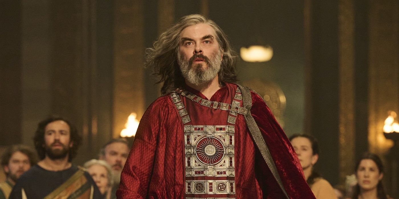 Pharazon (Trystan Gravelle) stands in a red robe with a crowd behind in The Rings of Power Season 2