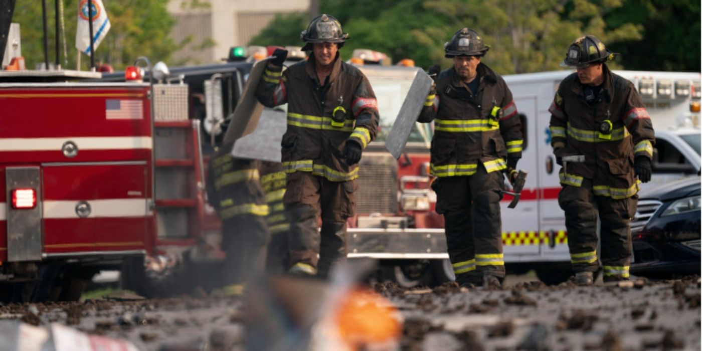 Taylor Kinney as Kelly Severide and Joe Minoso as Joe Cruz walk through an accident scene on Chicago Fire