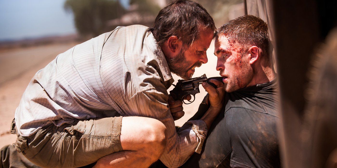 Guy Pearce as Eric interrogating Robert Pattinson as Rey for information on where his car went in The Rover.