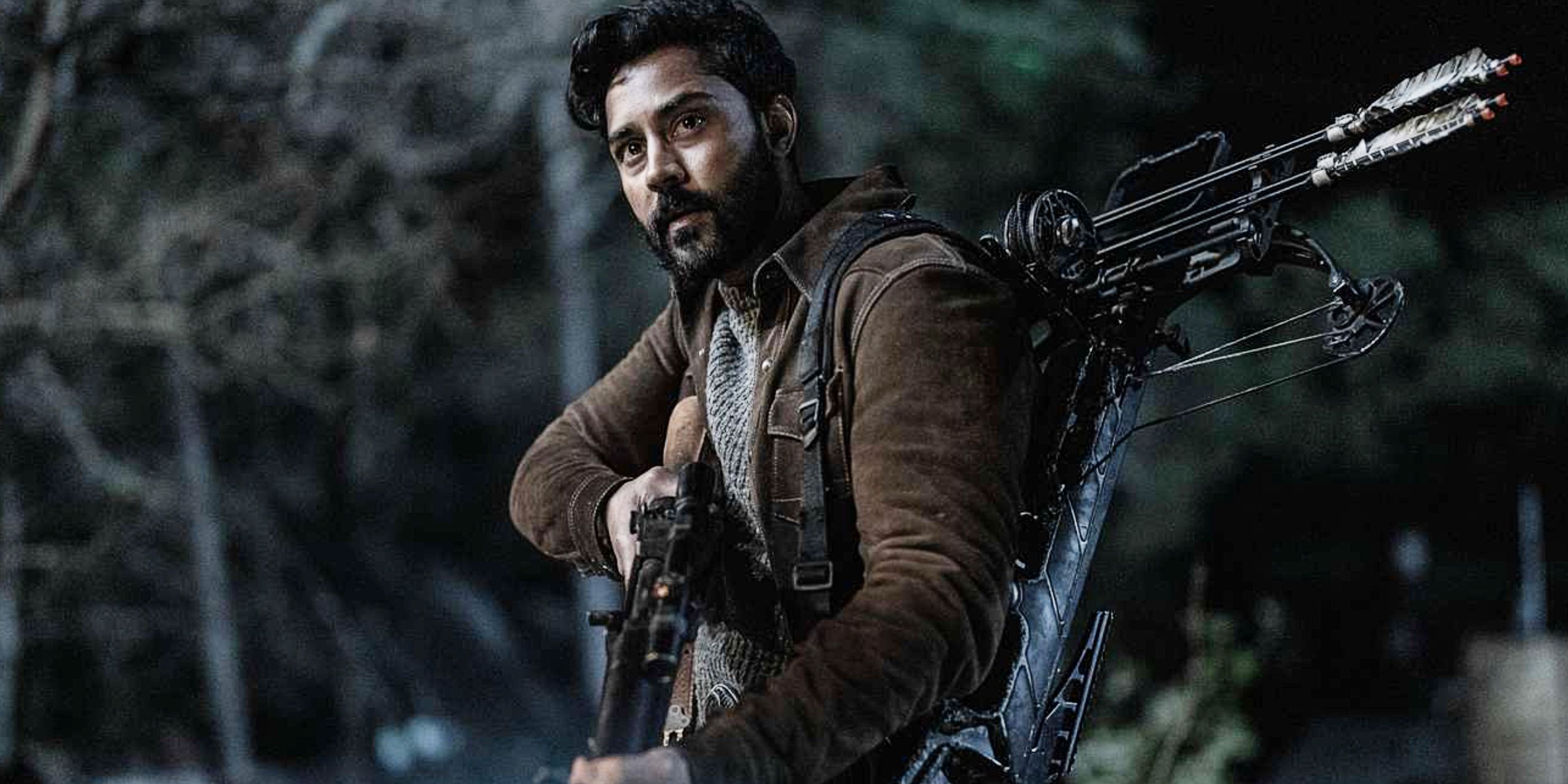 Ash (Manish Dayal) holding a gun and crossbow on The Walking Dead: Daryl Dixon Season 2