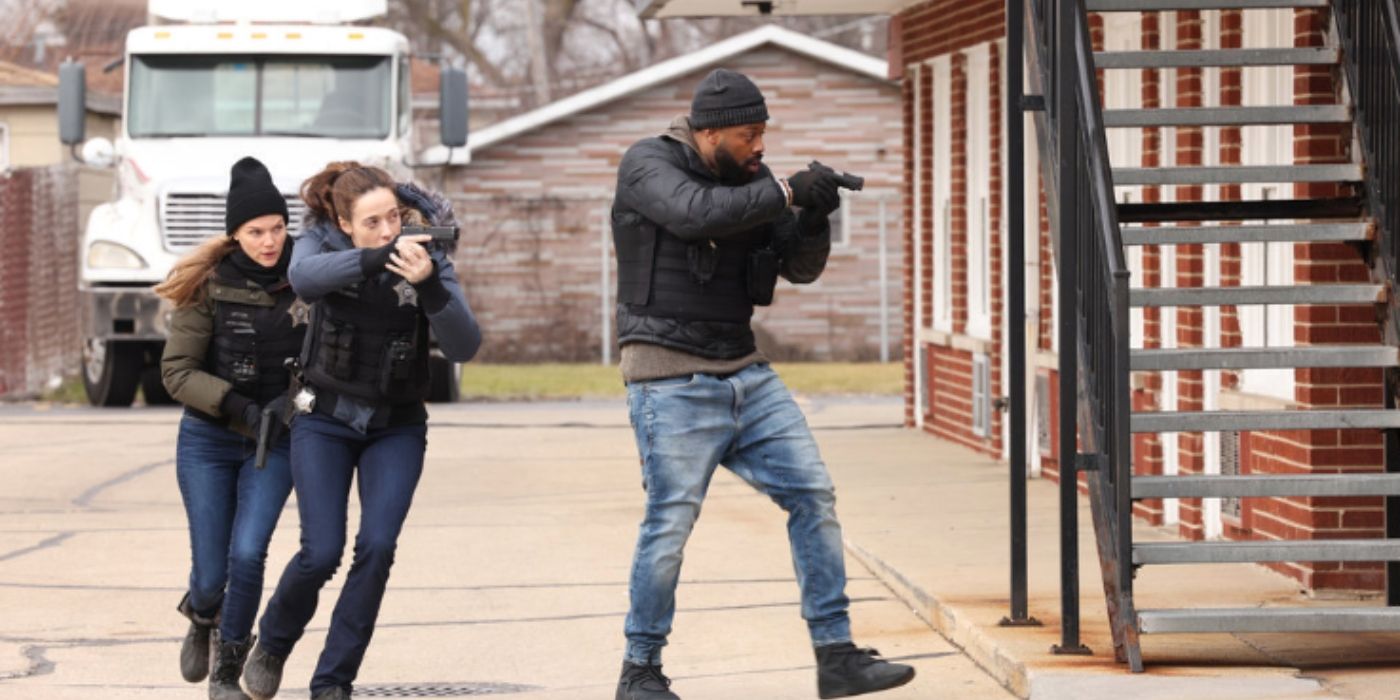 Tracy Spiridakos as Haley Upton, Marina Squerciati as Kim Burgess, and LaRoyce Hawkins as Kevin Atwater move into a crime scene while holding guns and wearing bullet proof vests on Chicago PD