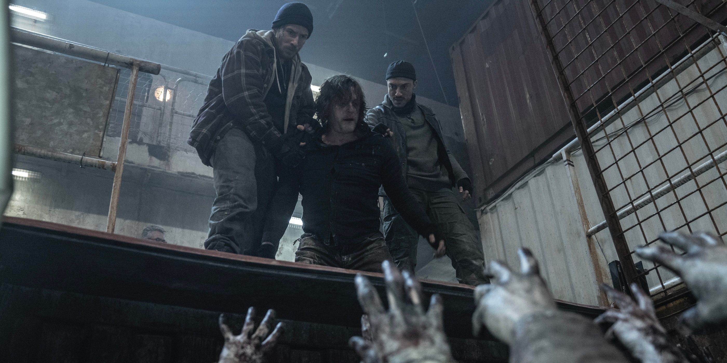 Two men holding Daryl Dixon down as walkers grab at him on The Walking Dead: Daryl Dixon