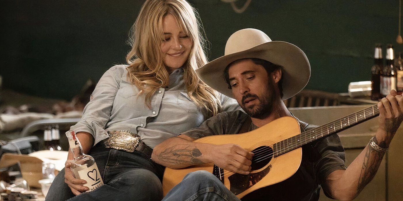 Walker plays guitar while Laramie sits with him on Yellowstone.