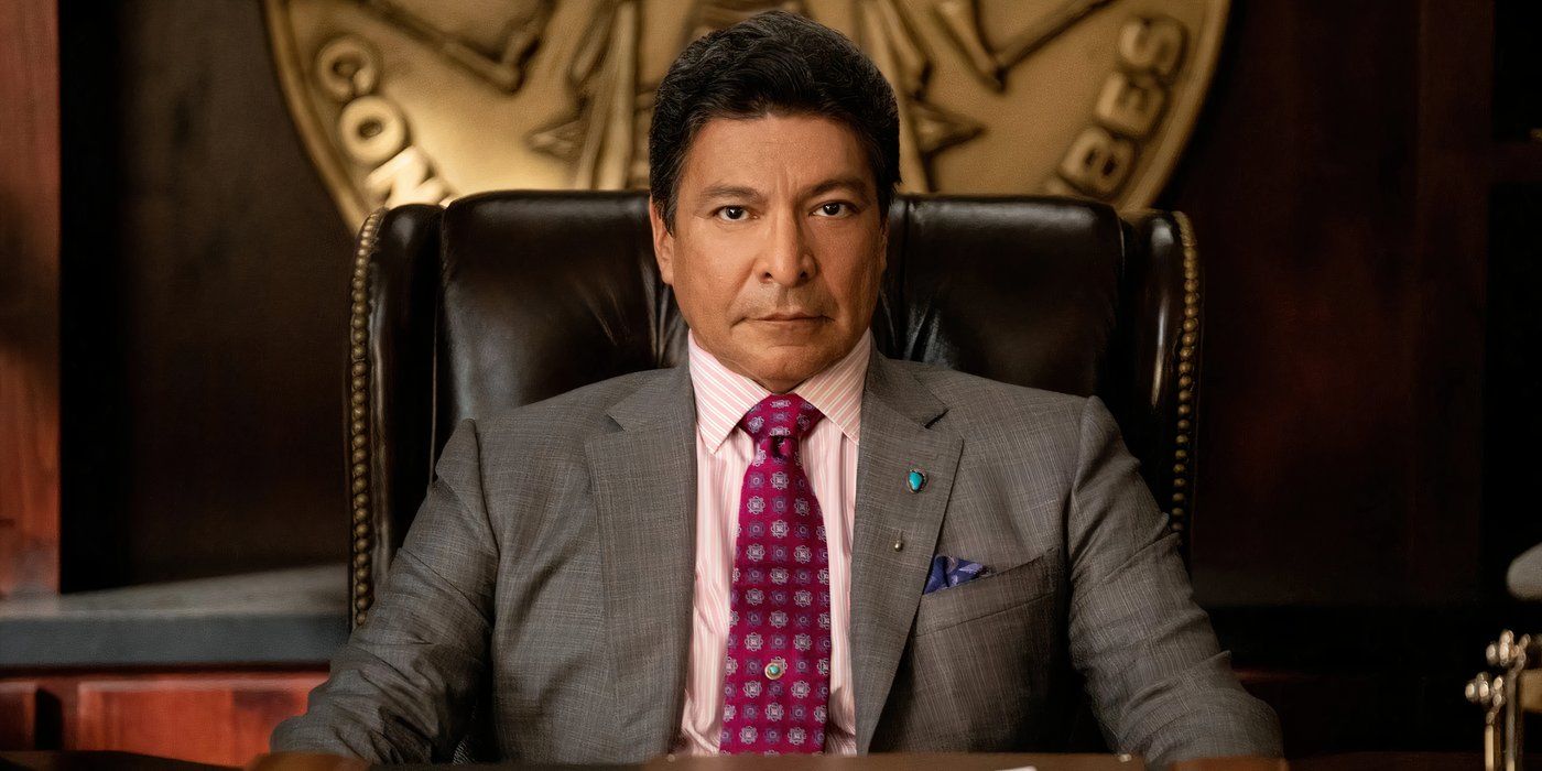 Gil Birmingham as Thomas Rainwater sitting at his desk in his casino taking inquiries from someone in Yellowstone.