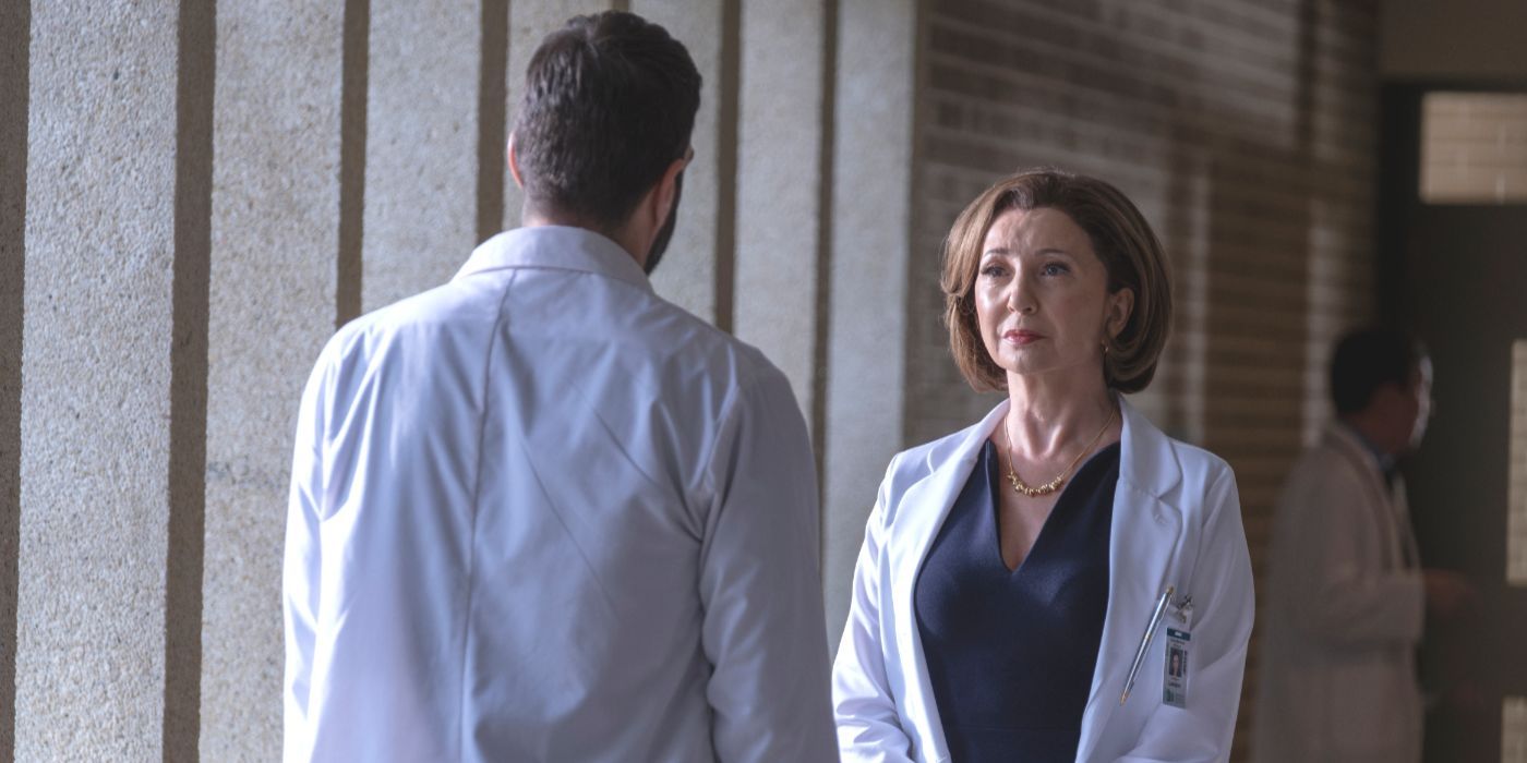 Muriel (Donna Murphy) stands in a hall with Wolf (Zachary Quinto) in front of her in Brilliant Minds