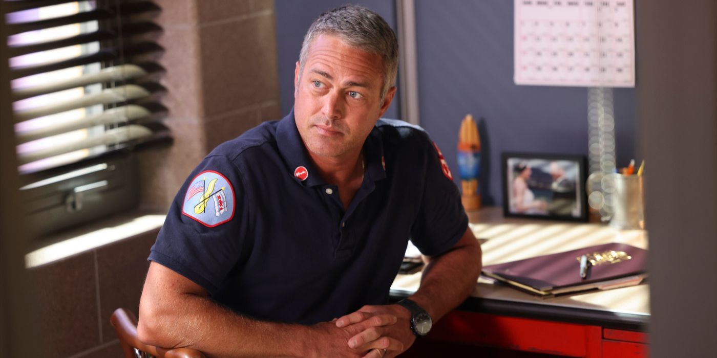 Kelly Severide, played by Taylor Kinney, sits in uniform turned away from his desk in Chicago Fire