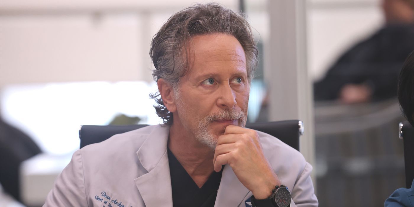 Dean Archer, played by Steven Weber, sits in a lab coat with his hand on his chin in Chicago Med