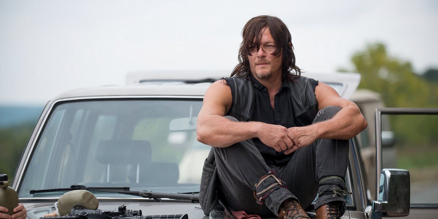 Daryl sitting on a hood of a car