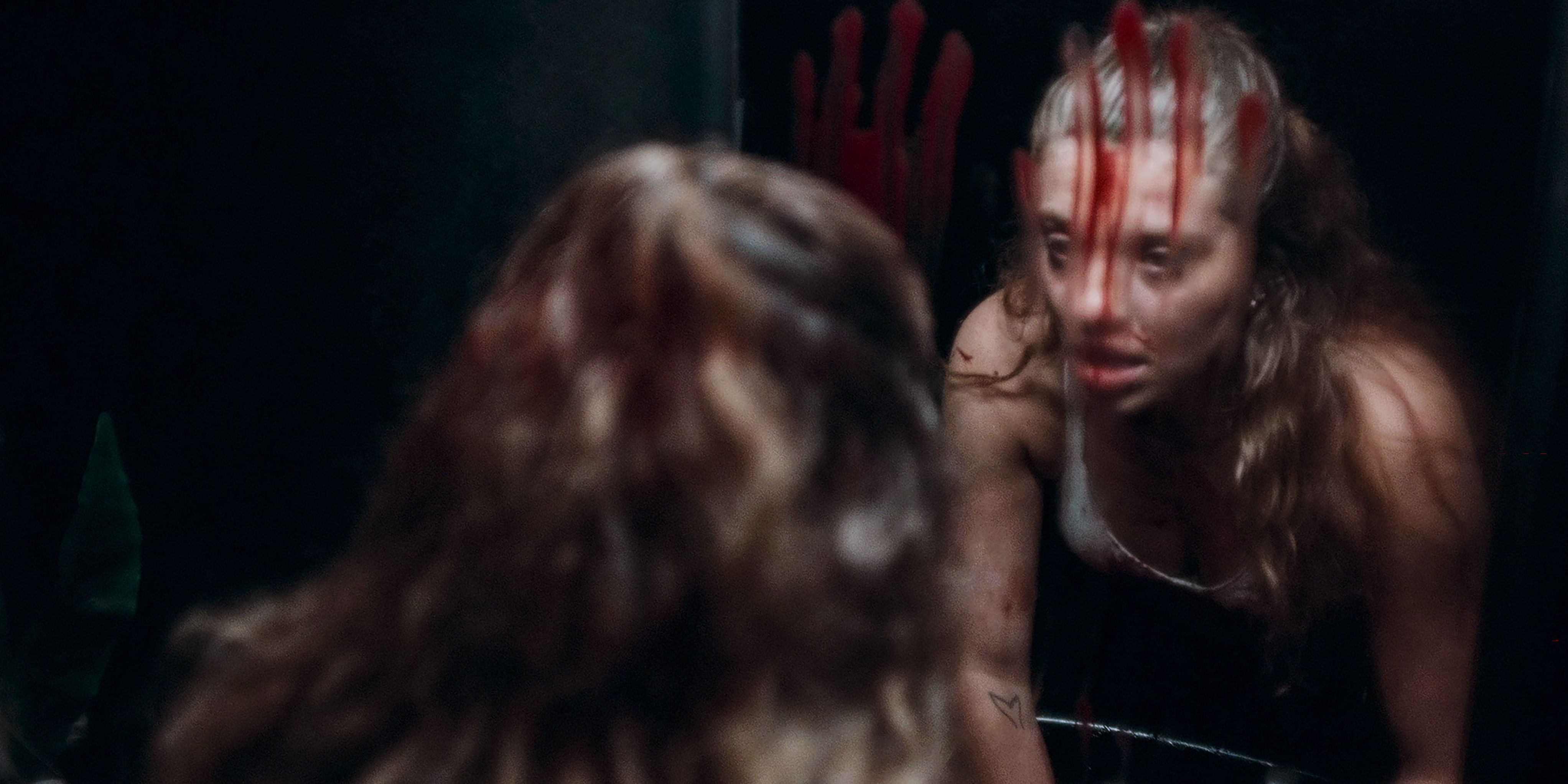 A confused Anaïs stares into the bloody mirror in MadS