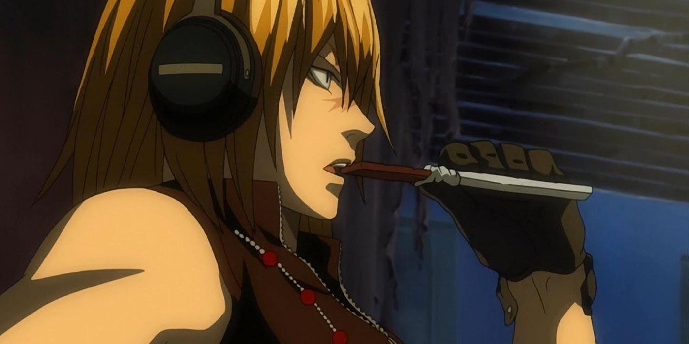 Mello eats chocolate while using headphones.