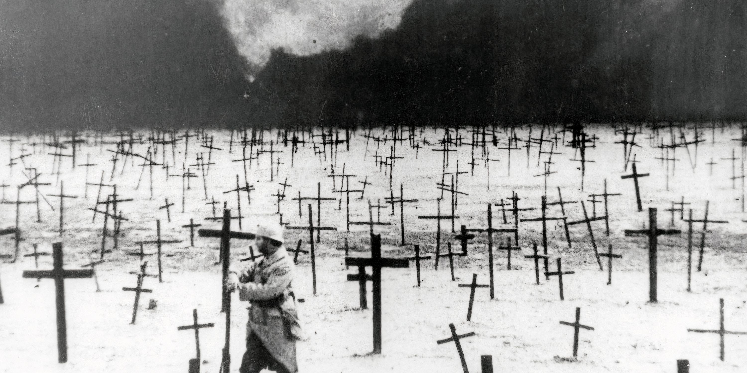 A man drives crosses into the ground during J'Accuse (1919)