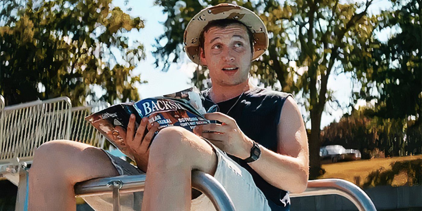 Shane, played by Nick Robinson, reads a magazine while looking offscreen in 