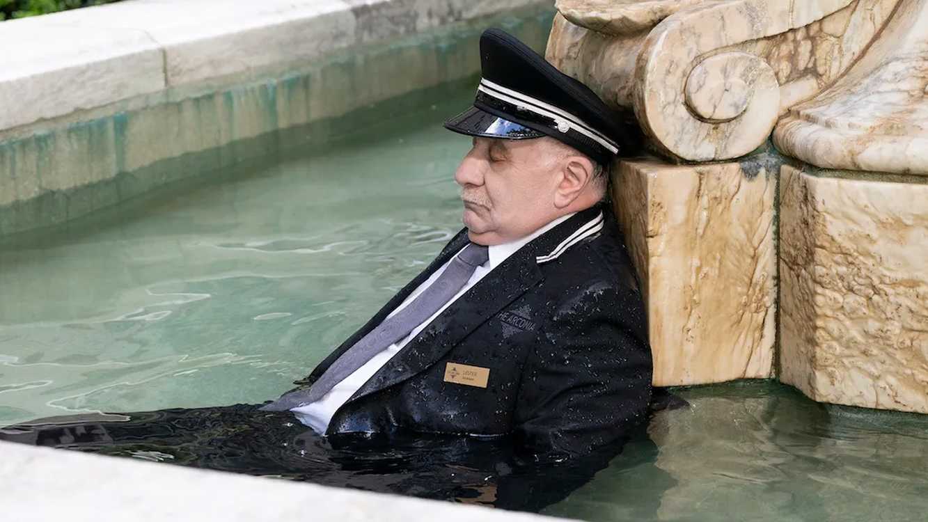 The doorman Lester dead in the Arconia's fountain on Only Murders in the Building.
