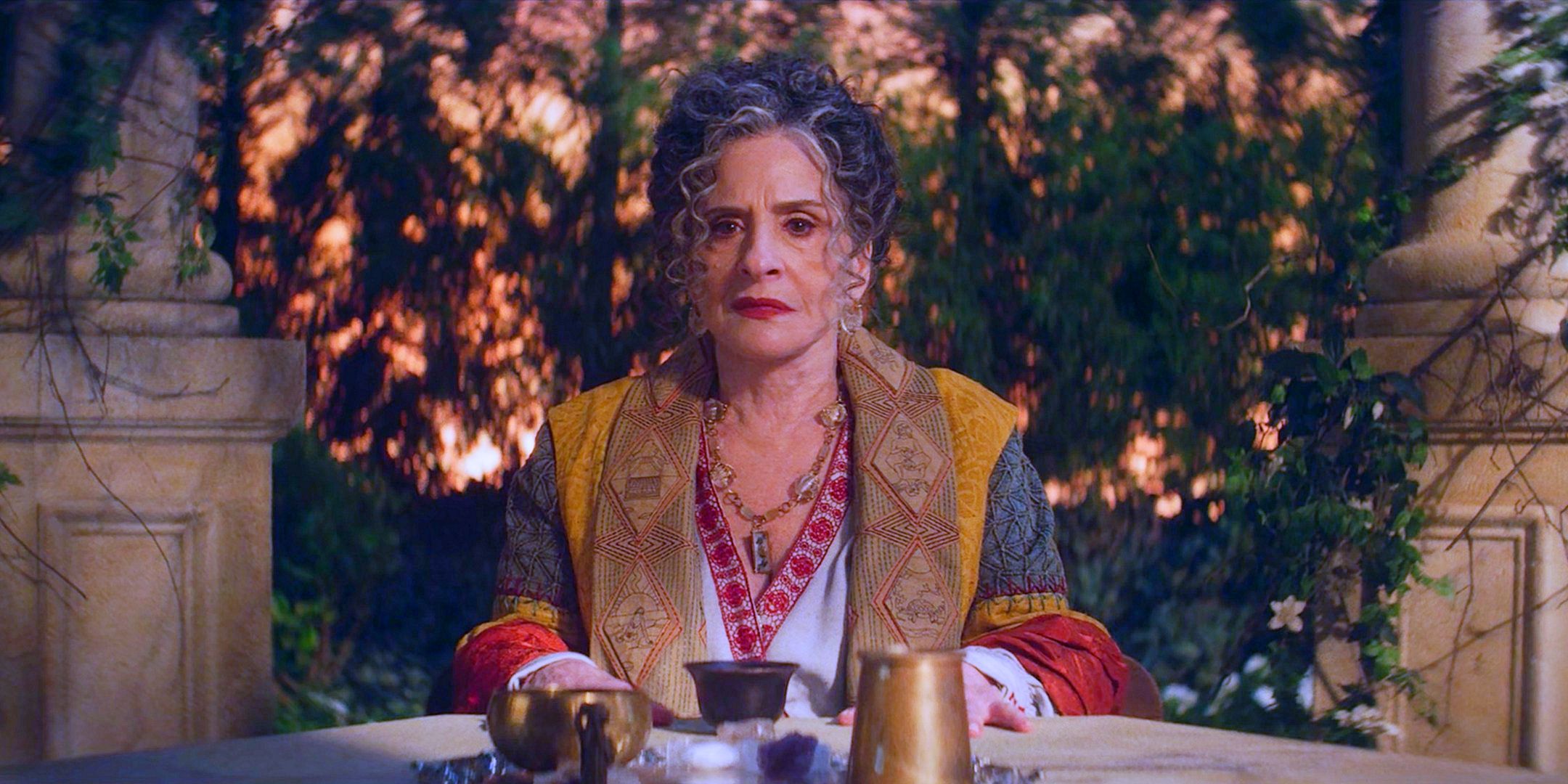 Patti LuPone as adult Lilia Calderu sitting in an Italian garden from Agatha All Along