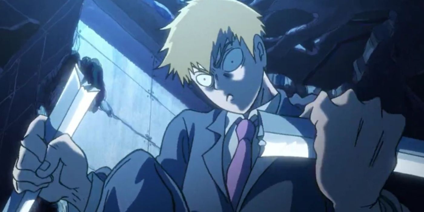 Reigen Arataka sostiene armas con ambas manos mientras parece enojado en Mob Psycho 100.