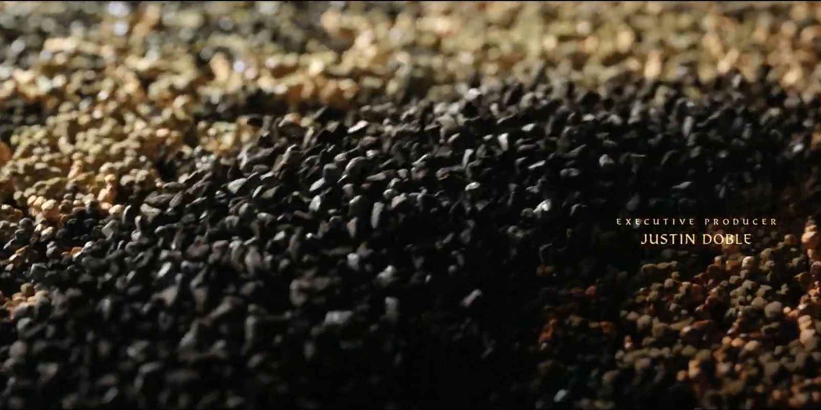 A closeup of the black sand from The Rings of Power's Intro Sequence