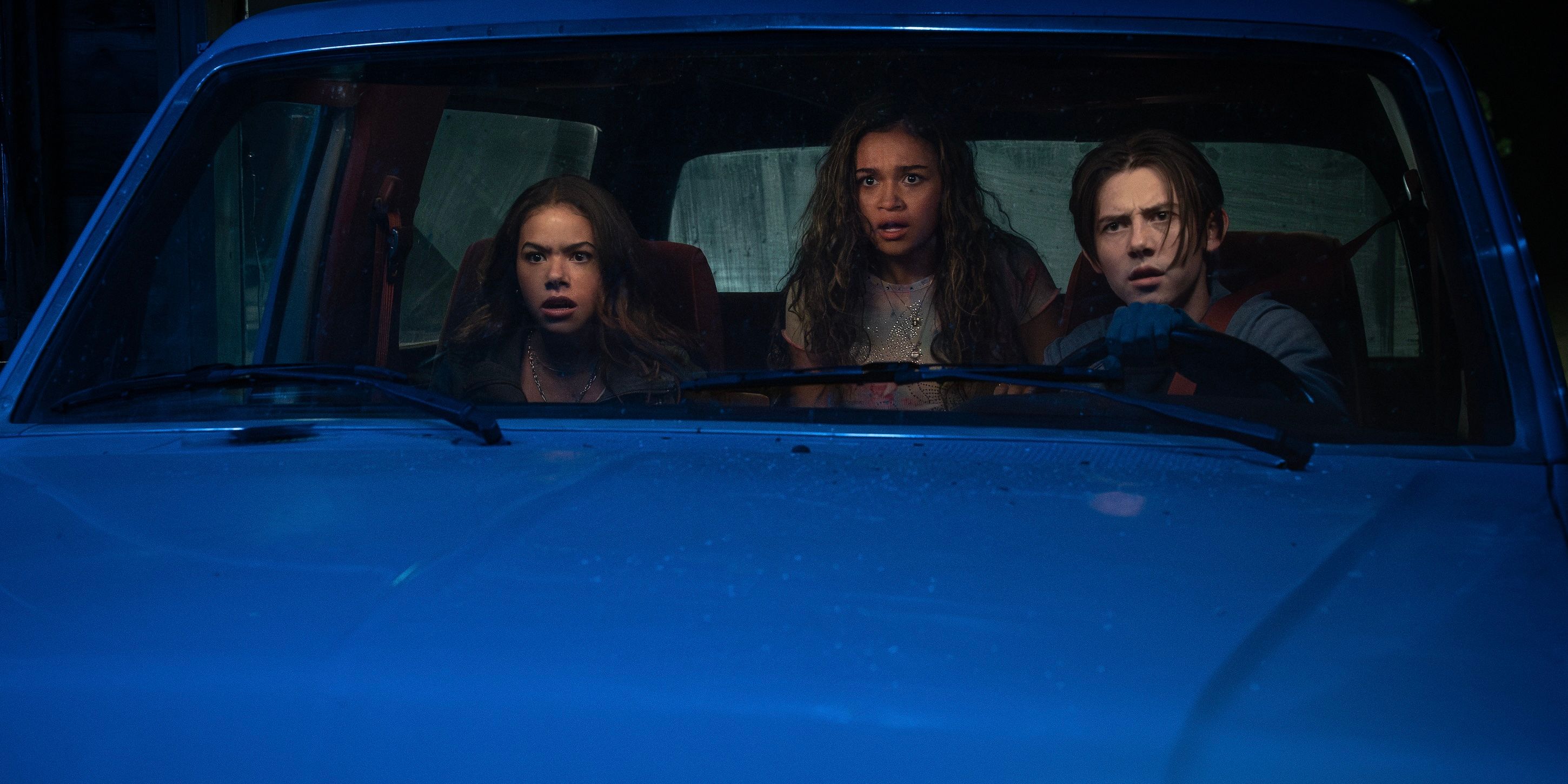 Antonia Gentry, Madison Bailey and Griffin Gluck sit worried in a car at night in the Netflix series “Time Cut”.