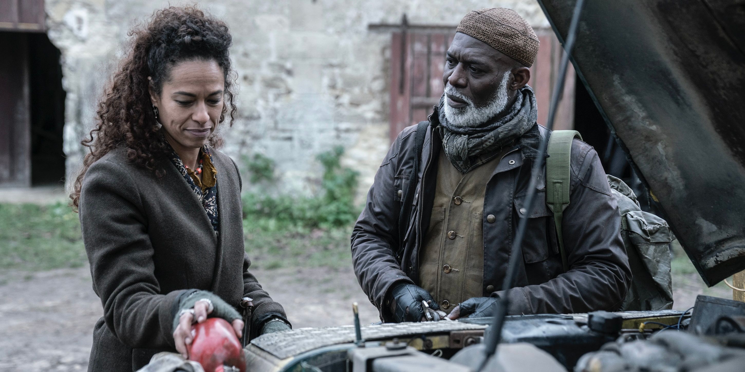 Alika (Soraya Hachoumi) and Fallou (Eriq Ebouaney) work on a car on The Walking Dead: Daryl Dixon