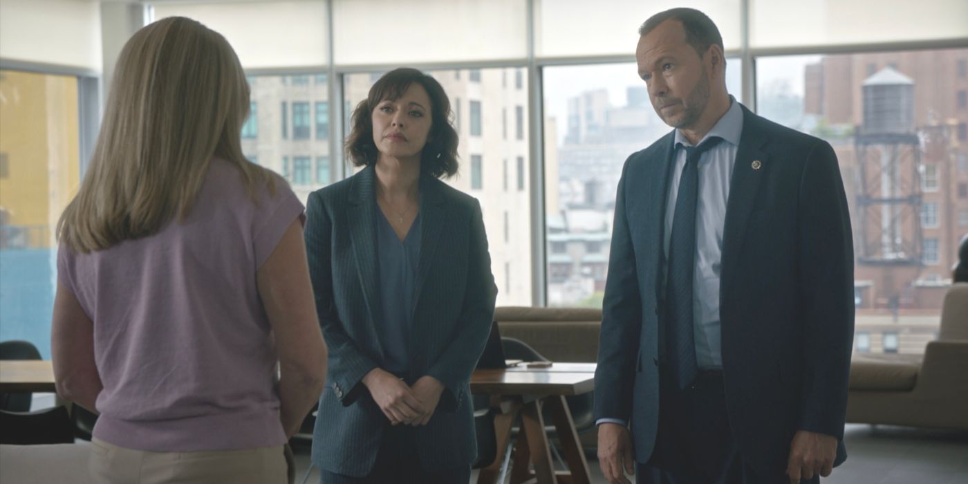 Maria Baez and Danny Reagan stand in front of a witness they're interviewing in Blue Bloods