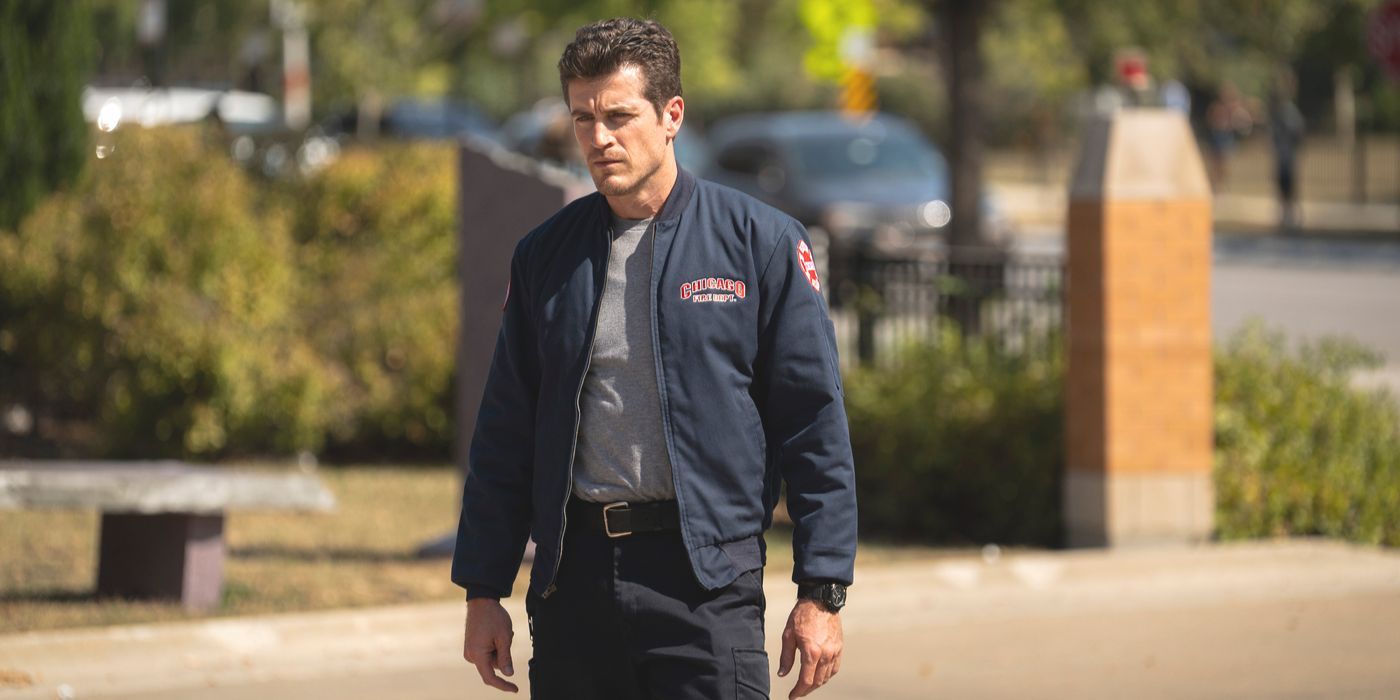 Sam Carver, played by Jake Lockett, stands in his firehouse jacket outside in Chicago Fire Season 13