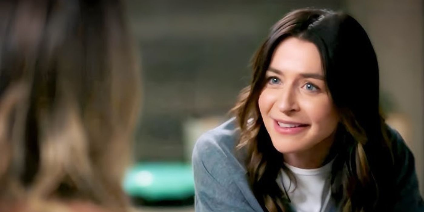 Amelia Shepherd smiles at Jo Wilson while wearing a grey sweatshirt and white tee on Grey's Anatomy