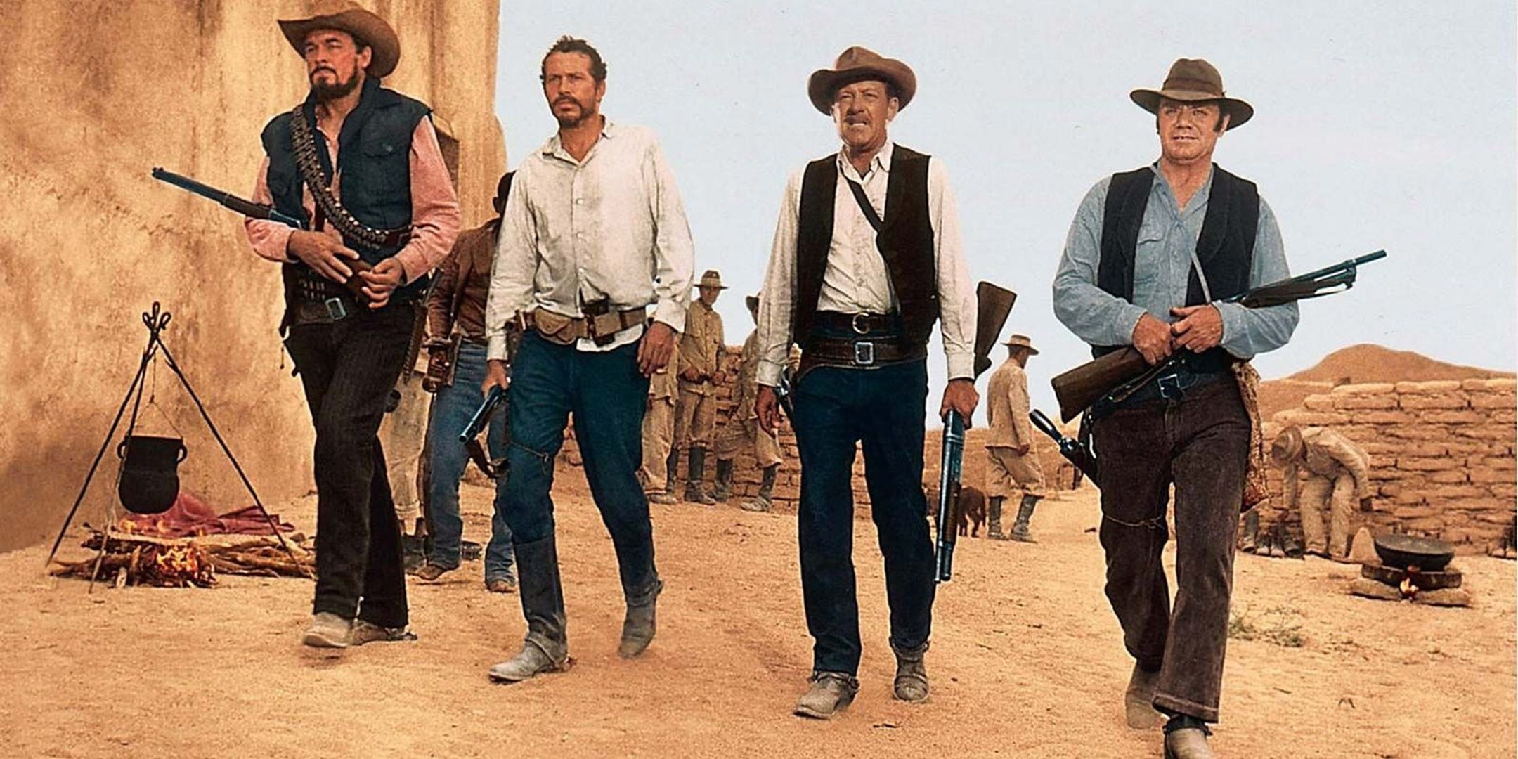 A group of armed men slowly walking in a line in The Wild Bunch