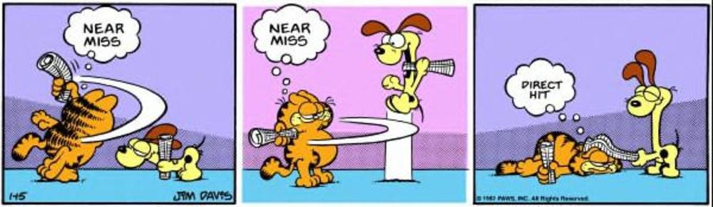 Garfield tenta acertar Odie com um papel.