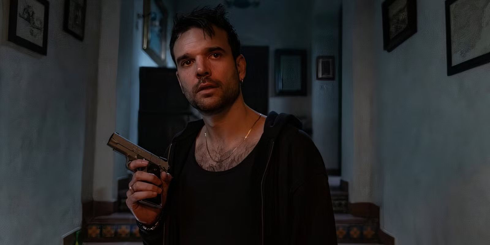 Alvaro holds a gun in the Day of the Jackal.