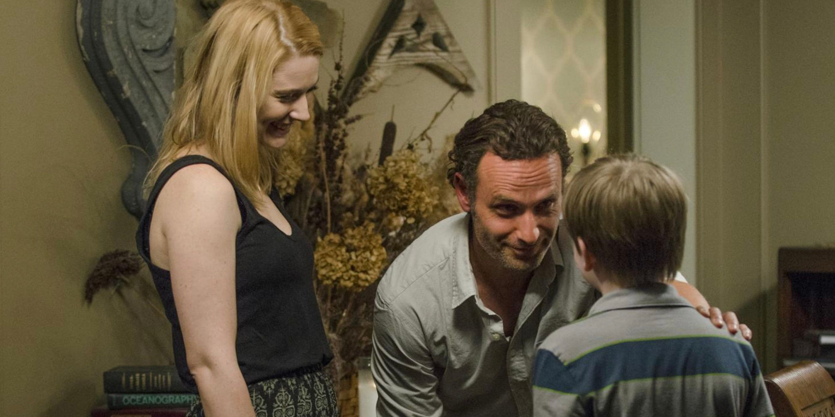 Jessie Anderson and Rick Grimes smiling at Sam Anderson on The Walking Dead