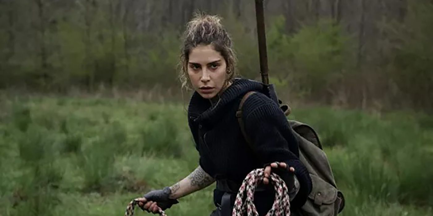 Manga with her hair up holding a rope trying to catch a horse in The Walking Dead.