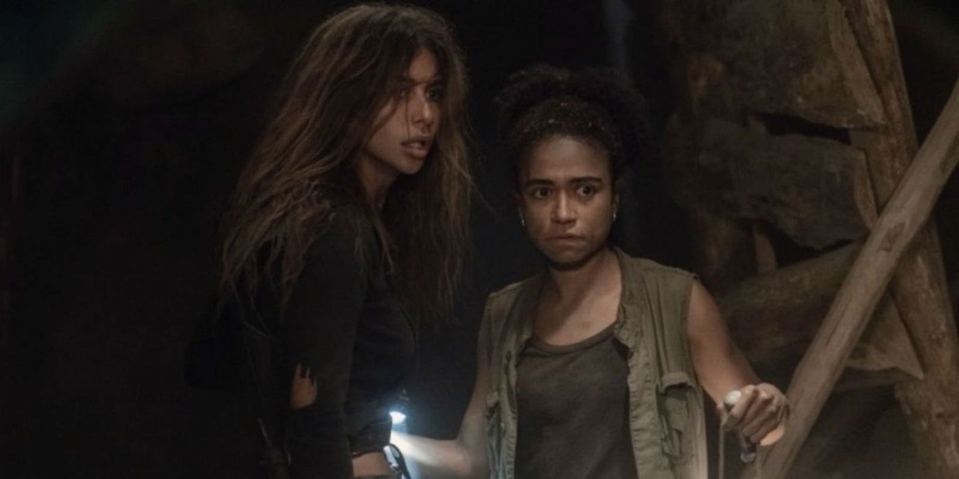 Magna and Connie in a cave holding flashlights in The Walking Dead.